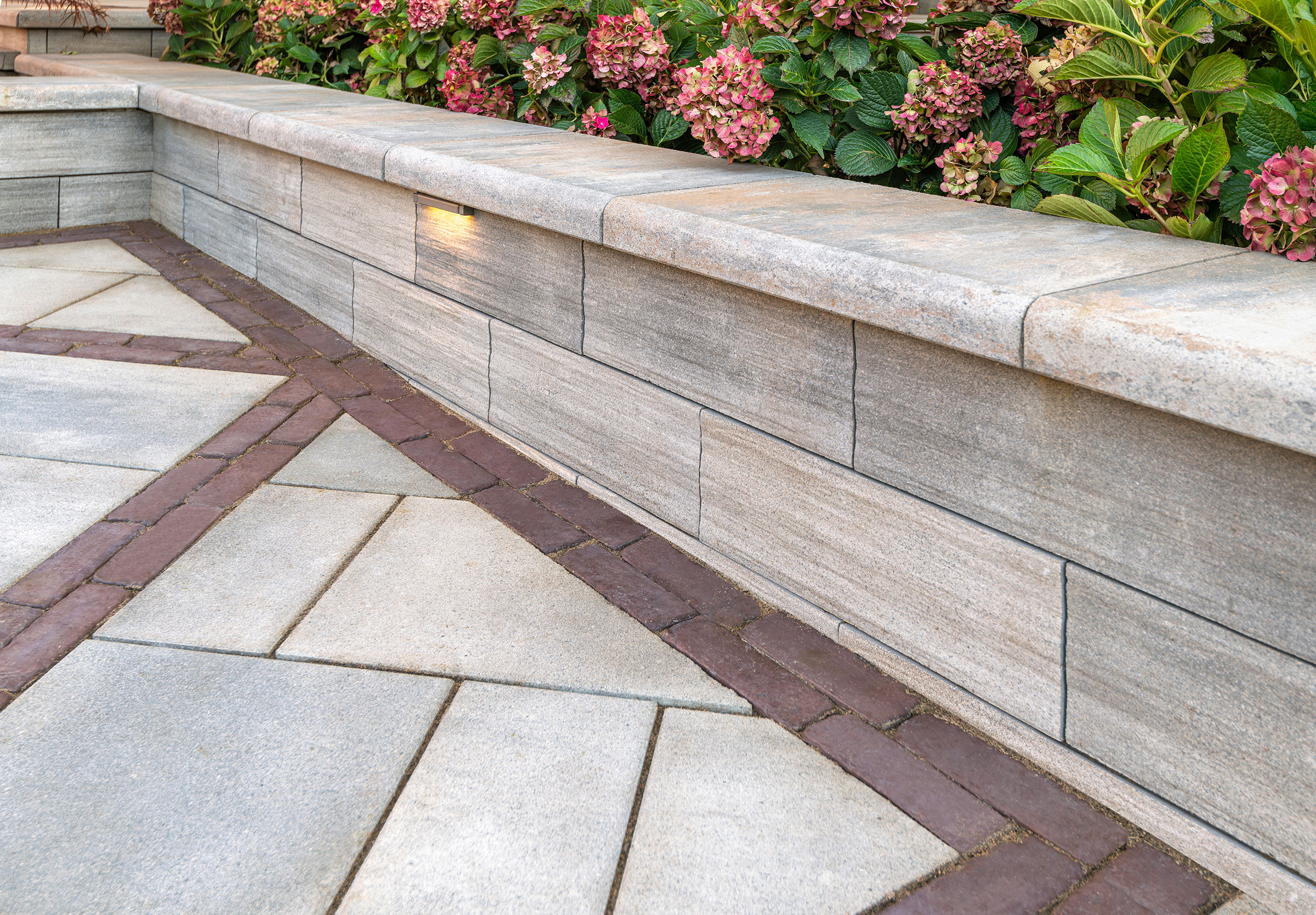 Natural stone seating wall with landscape lighting